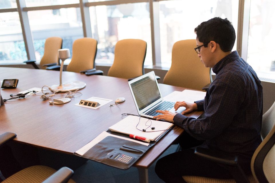 Professional on a video call in a meeting room